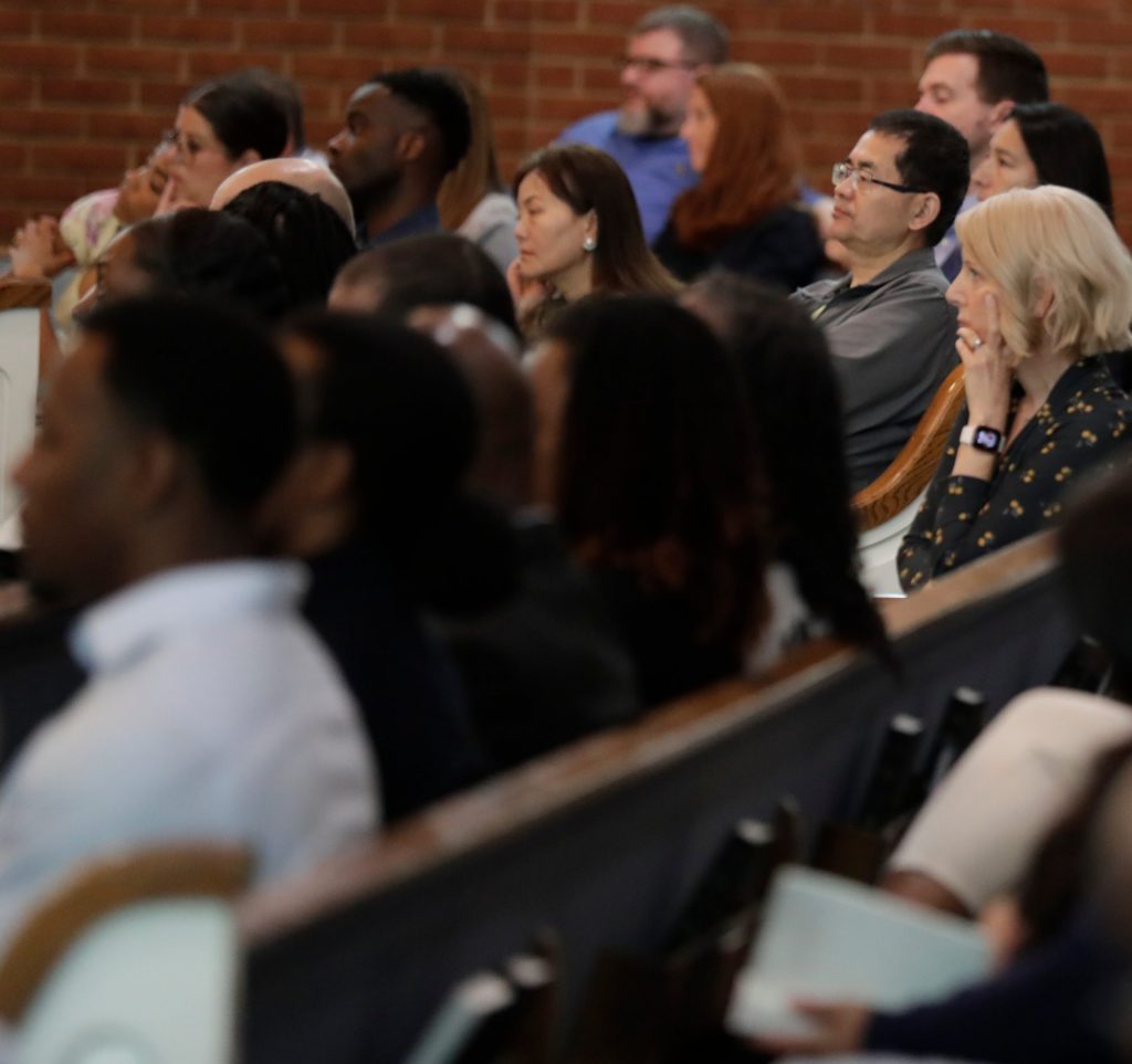 People sitting together and listening intently to the speaker.