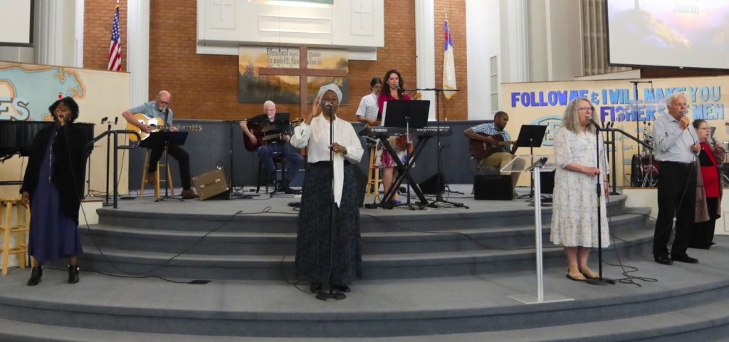 Music team on performing on stage during Sunday worship service.