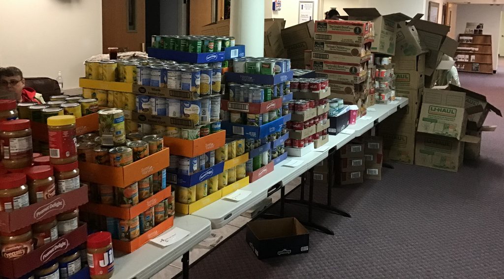 Table set up in church foyer with food ready to be packed into boxes for the food ministry.
